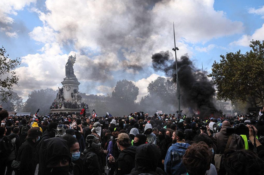 Demonstrators fill a boulevard Demonstrators fill a boulevard leading towards Place de la République as tear gas clouds the area.